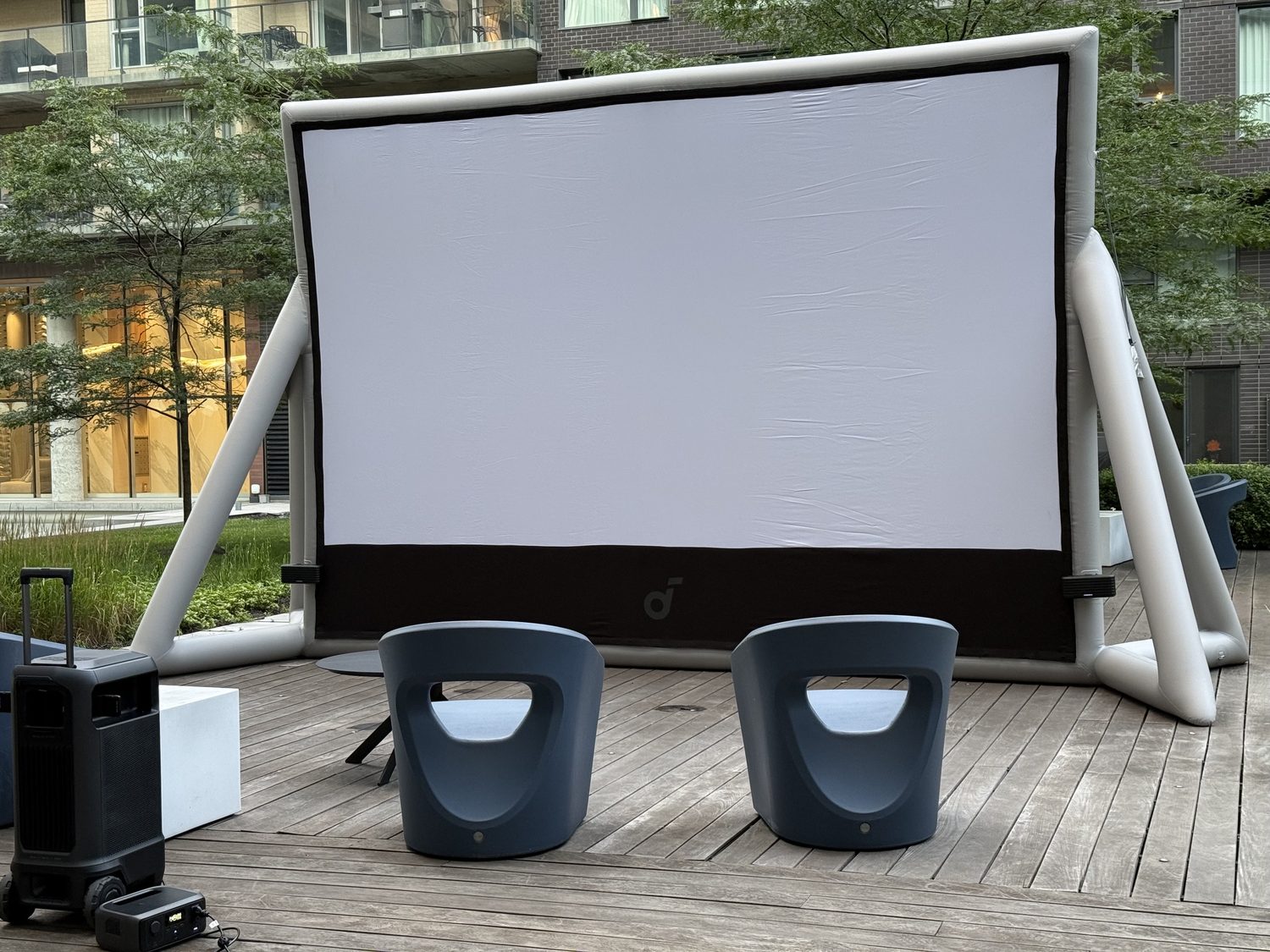 Big Screen MTL inflatable screen, projector, and speaker set up on a rooftop deck